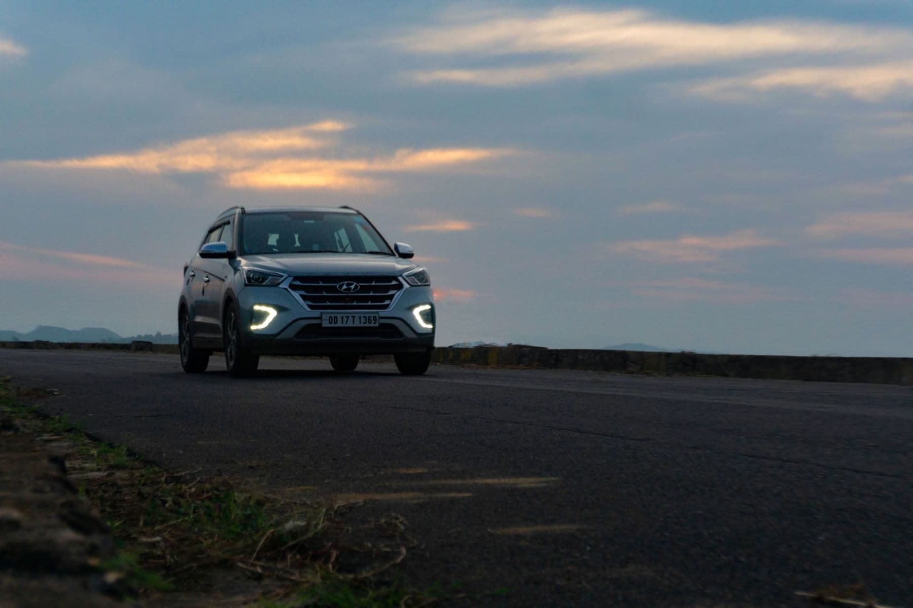 SUV on an open highway at dusk