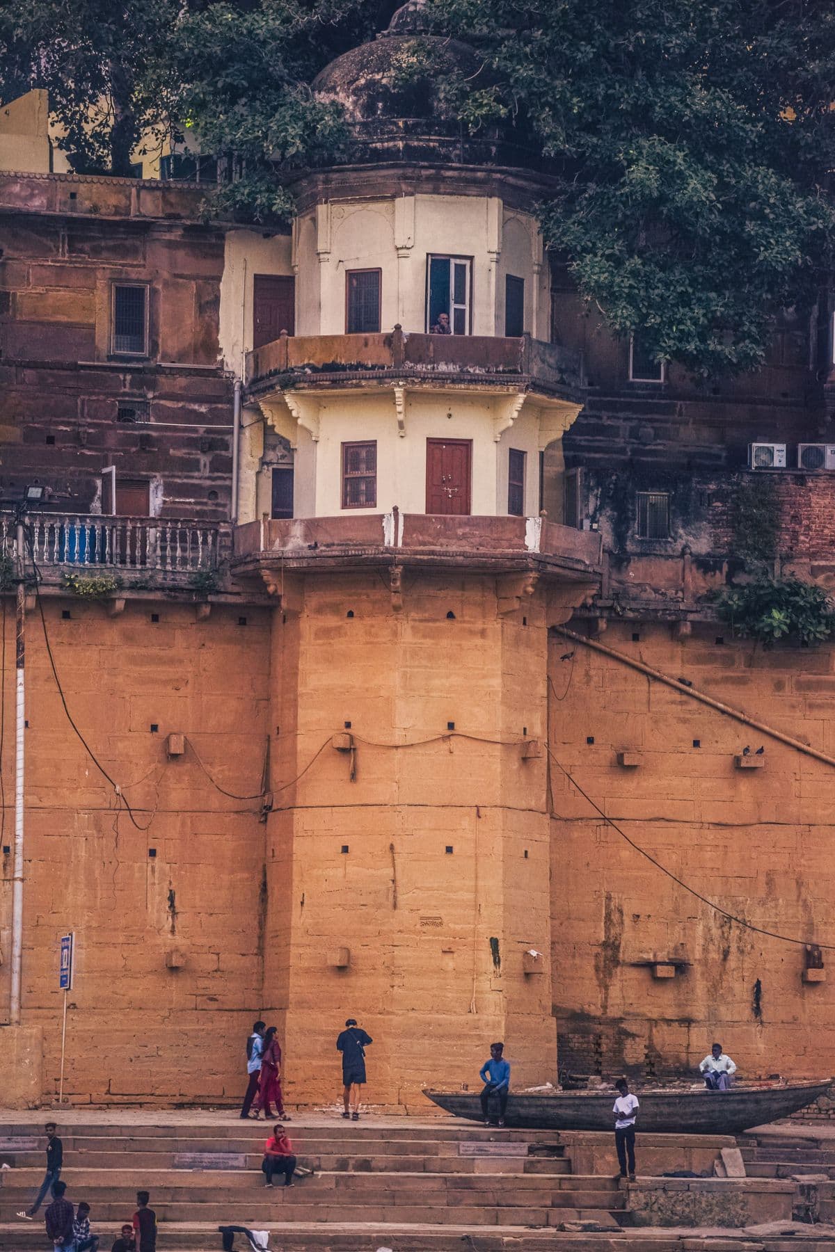 Old ghat building above the Ganga with a moored boat, Varanasi